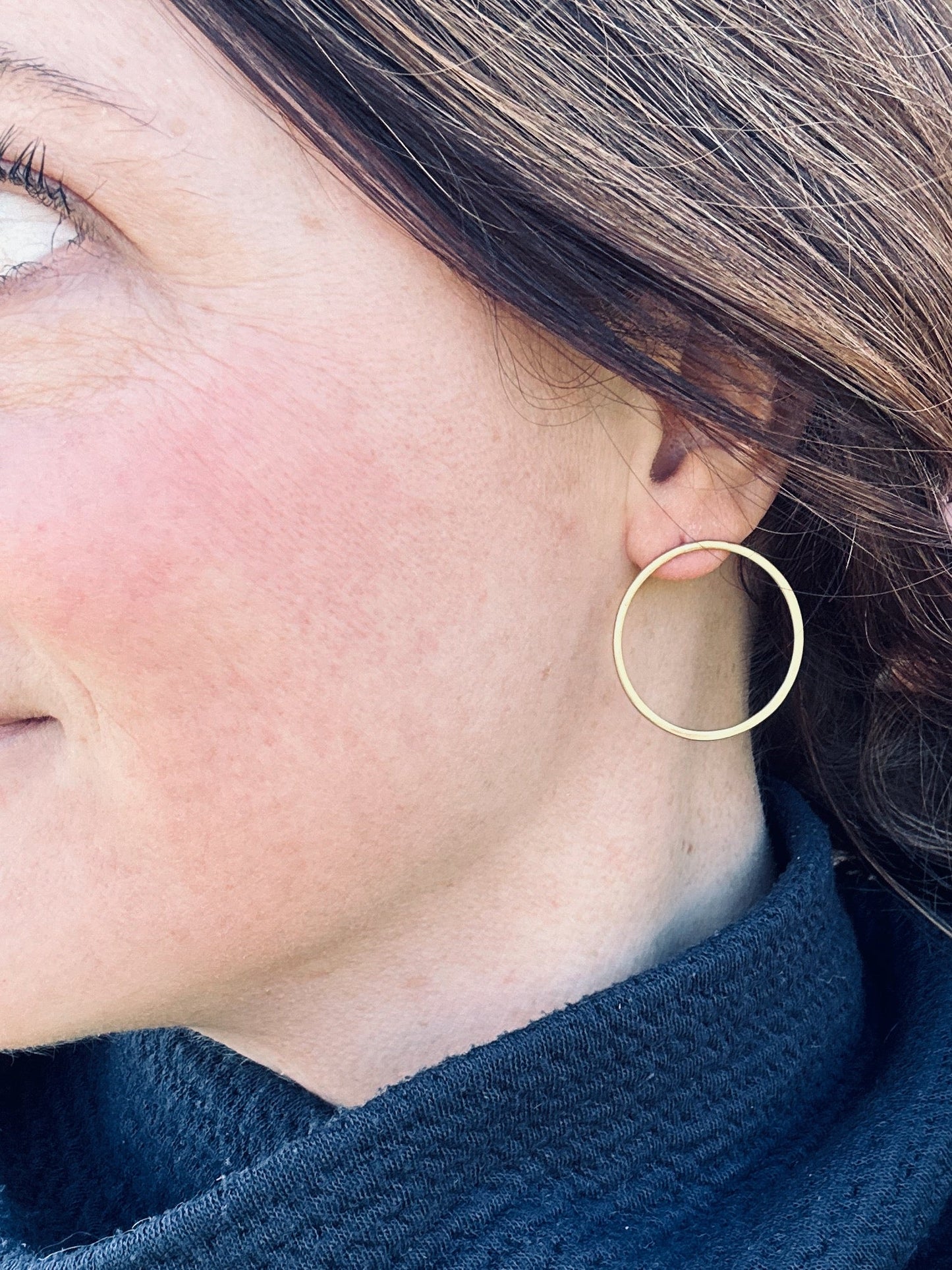 Brass satin circle stud earrings being worn, showing approximate size (3 cm).