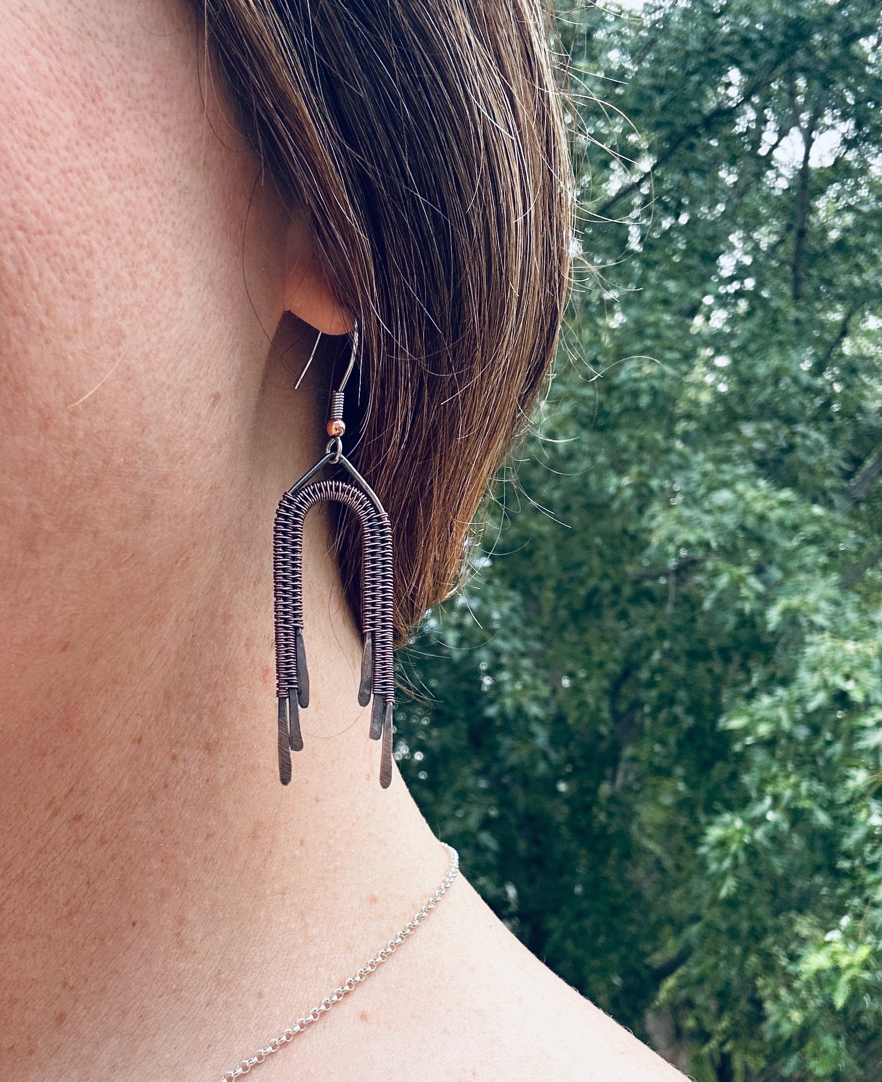 Copper wire wrapped rainbow dangle earrings being worn, showing approximate size (5 cm plus ear wire length).