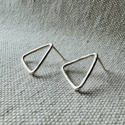 Close-up image of silver hammered triangle stud earrings, approximate size (2 cm).