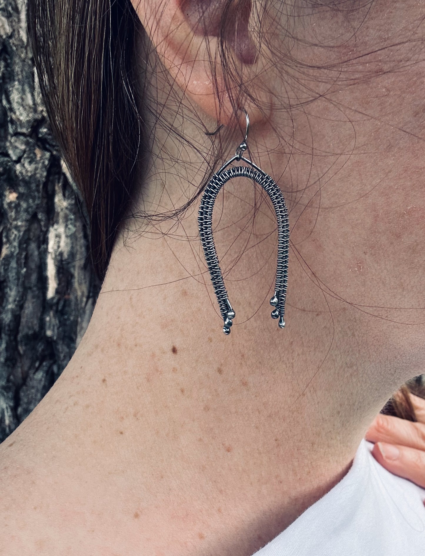 Silver wire wrapped rainbow dangle earrings being worn, showing approximate size (5 cm plus ear wire length).